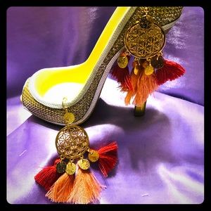 Gold tone dangle with peach/rust tassels